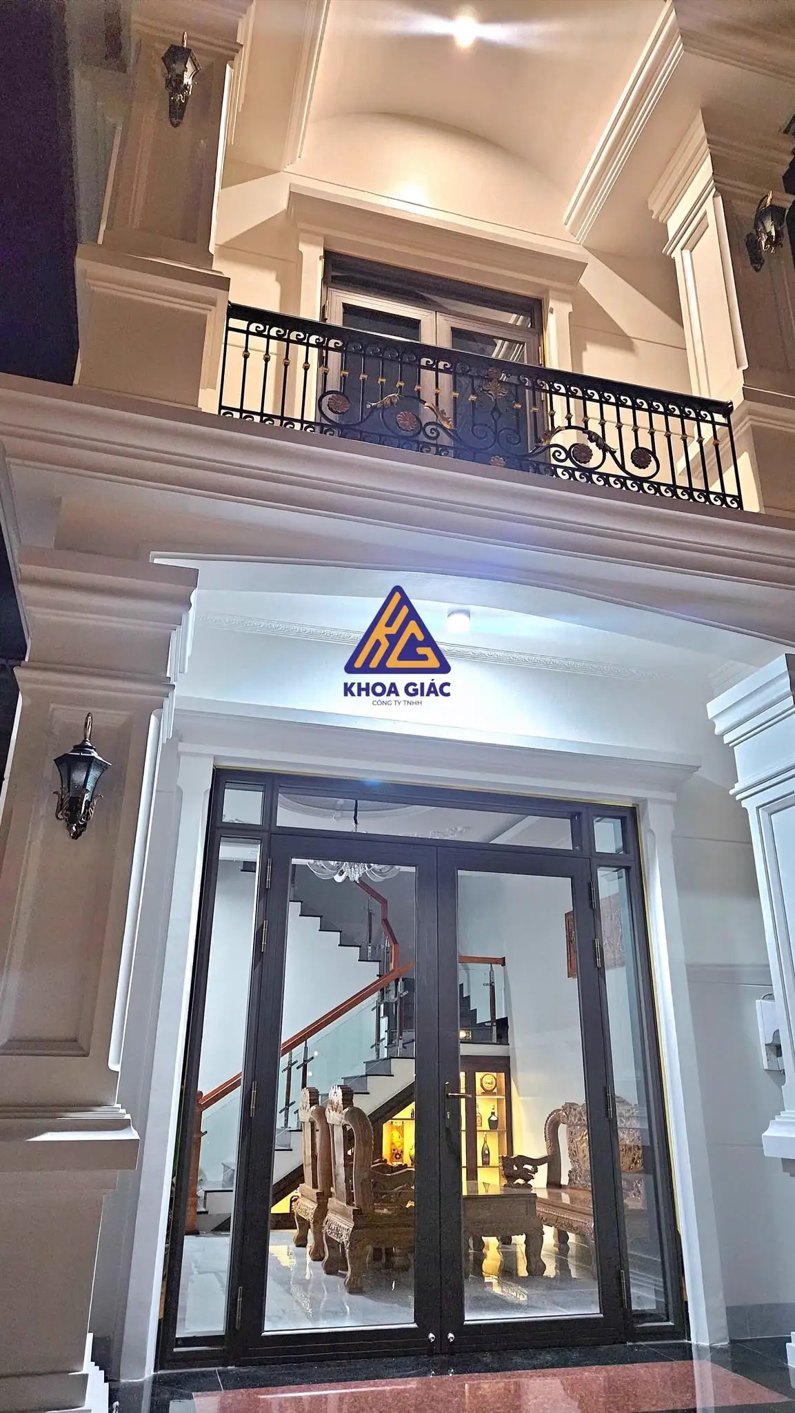 Cửa kính khung nhôm đen ở sảnh biệt thự tân cổ điển lúc lên đèn